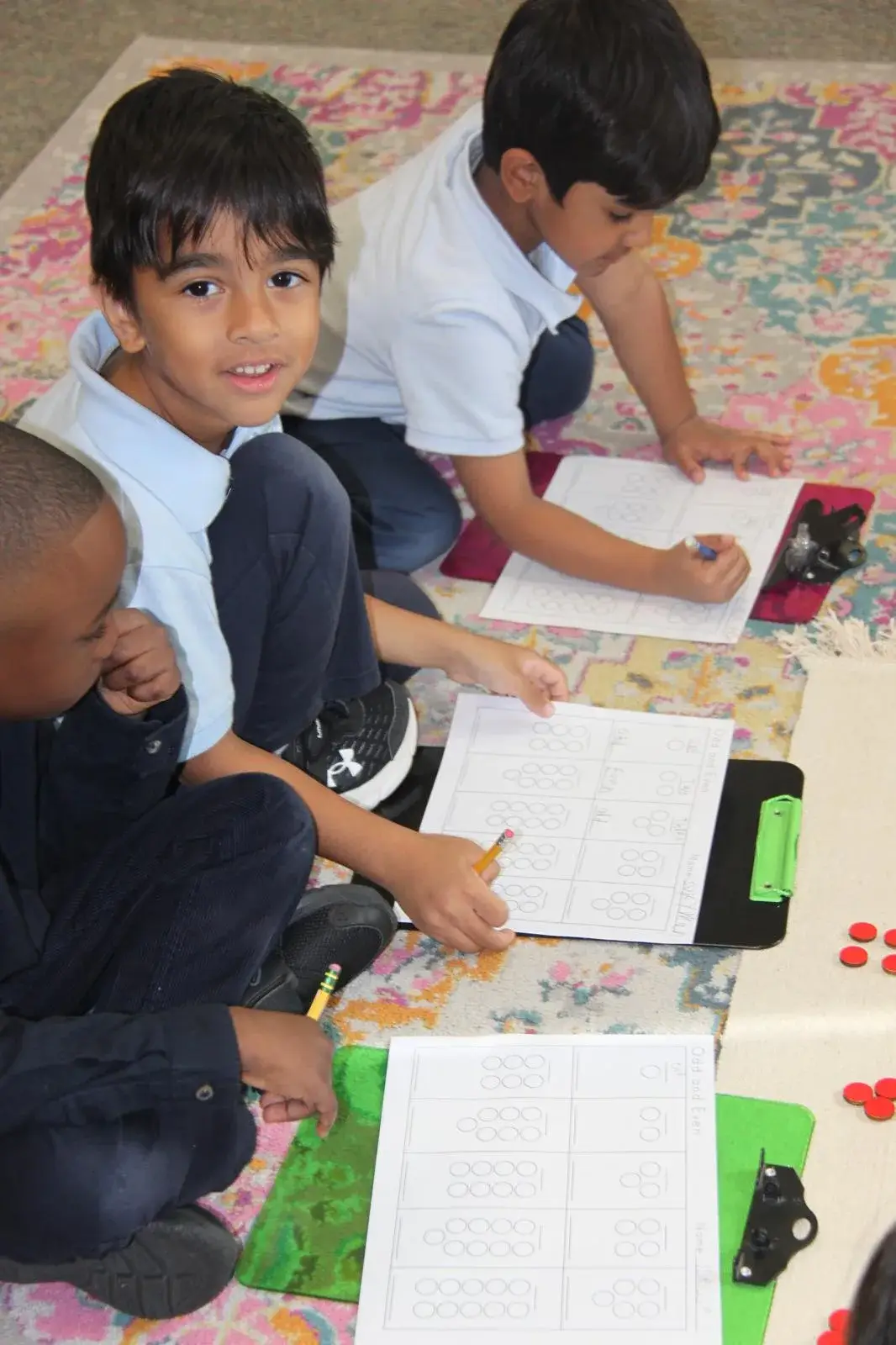 NAML students gathered around a table working on a project together