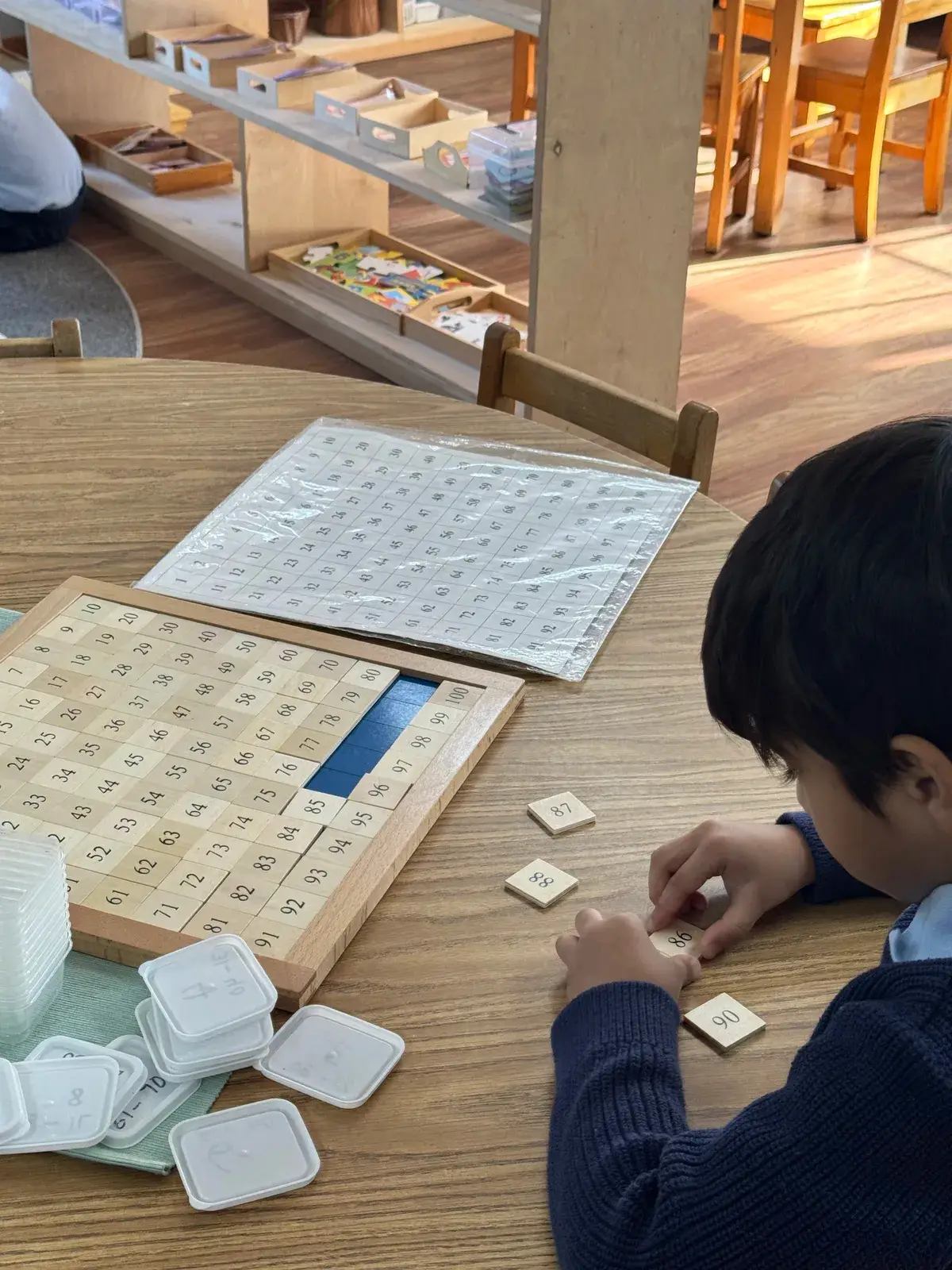NAML students working with hands-on learning materials at a table