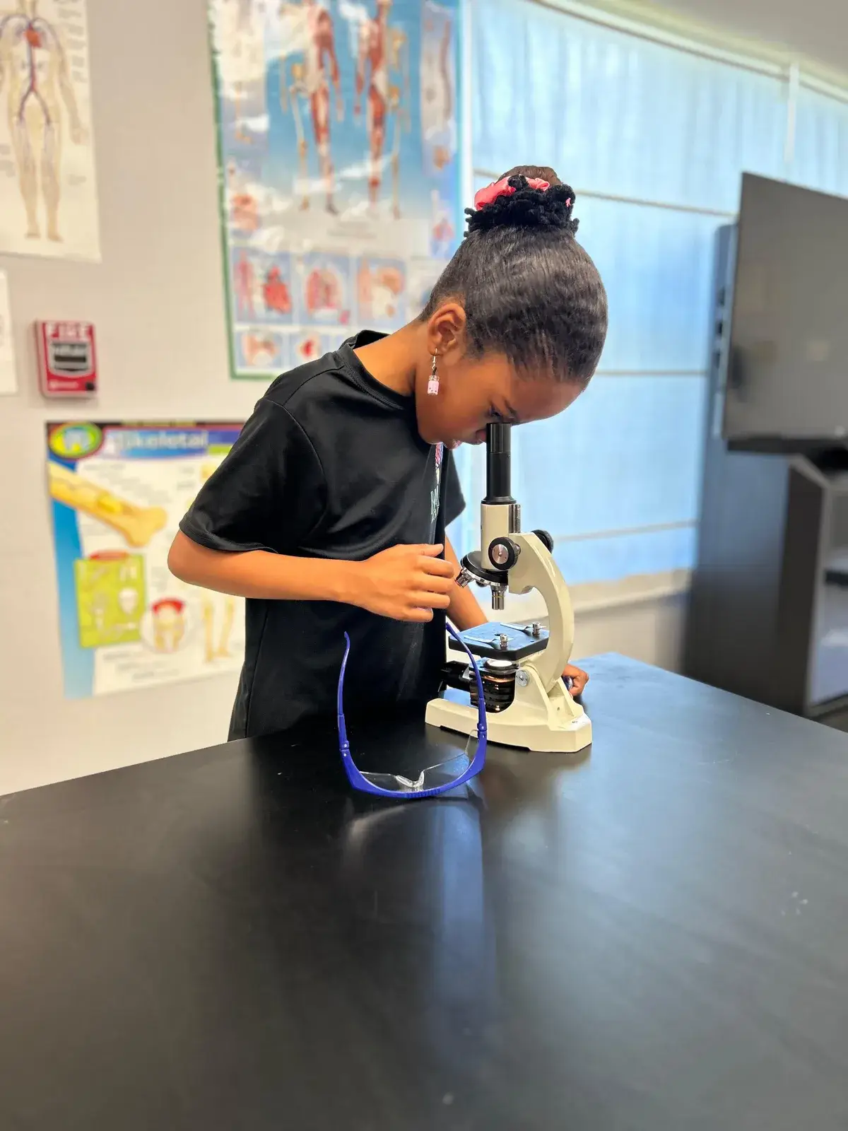 A NAML student at a practical-life activity station